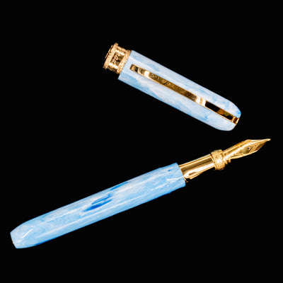Angled view of Visconti Comedia Paradiso fountain pen with cap off, showing shimmering resin.