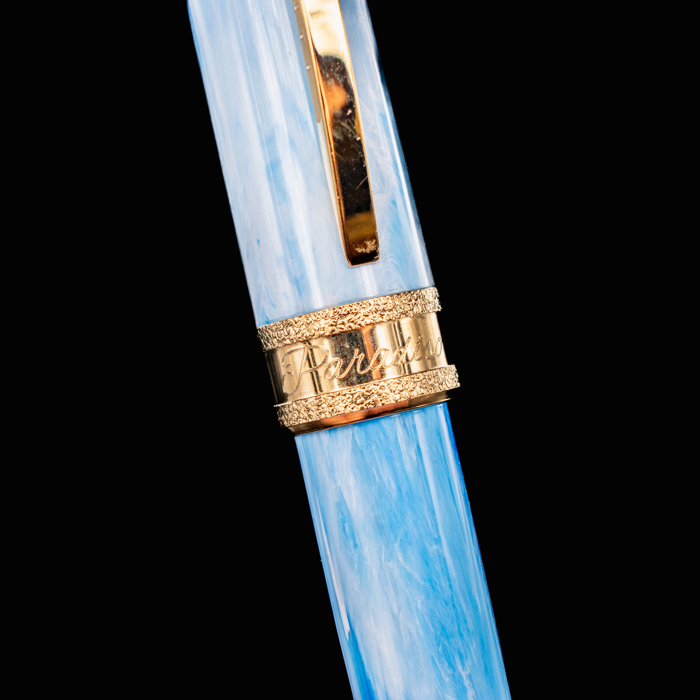 Detail of Visconti Comedia Paradiso cap band engraved with Paradiso in script and gold trim.