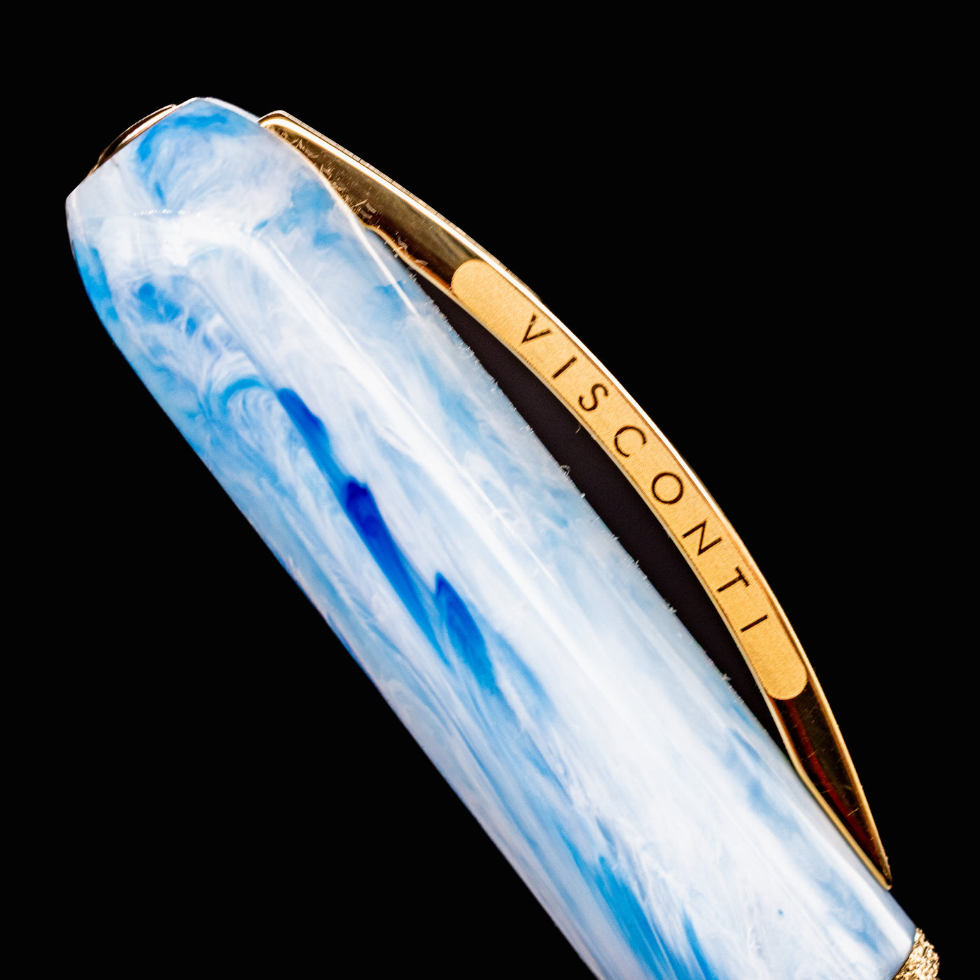 Close-up of Visconti Comedia Paradiso pen clip with gold VISCONTI branding on swirled blue cap.