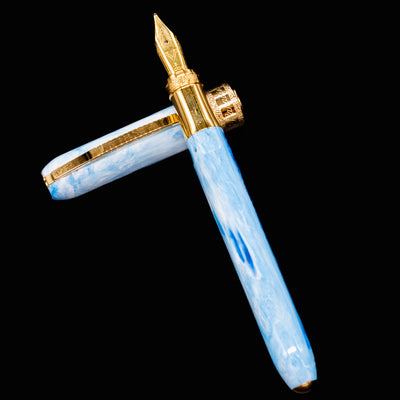 Visconti Comedia Paradiso fountain pen with cap and barrel laid flat to show blue and white resin.