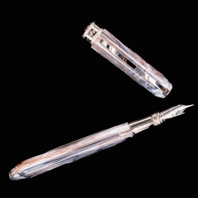 Visconti Comedia Purgatorio fountain pen with cap placed beside the open barrel on black background