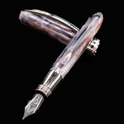 Close-up of Visconti Comedia Purgatorio fountain pen nib and marbled resin barrel
