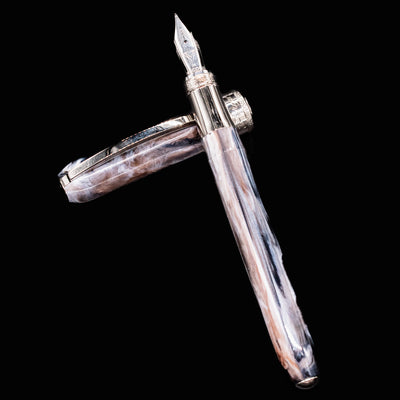 Visconti Comedia Purgatorio fountain pen with cap off and laid flat on black background