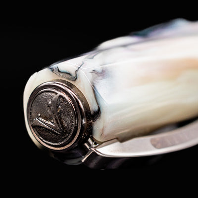 Close-up of the Visconti Divina Abalone Serial #1 cap finial with engraved V logo