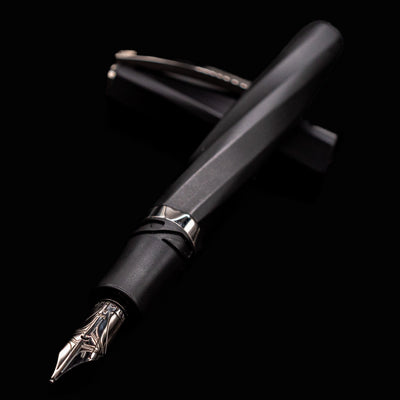Angled close-up of Visconti Divina Matte Black Fountain Pen showing silver nib and faceted barrel