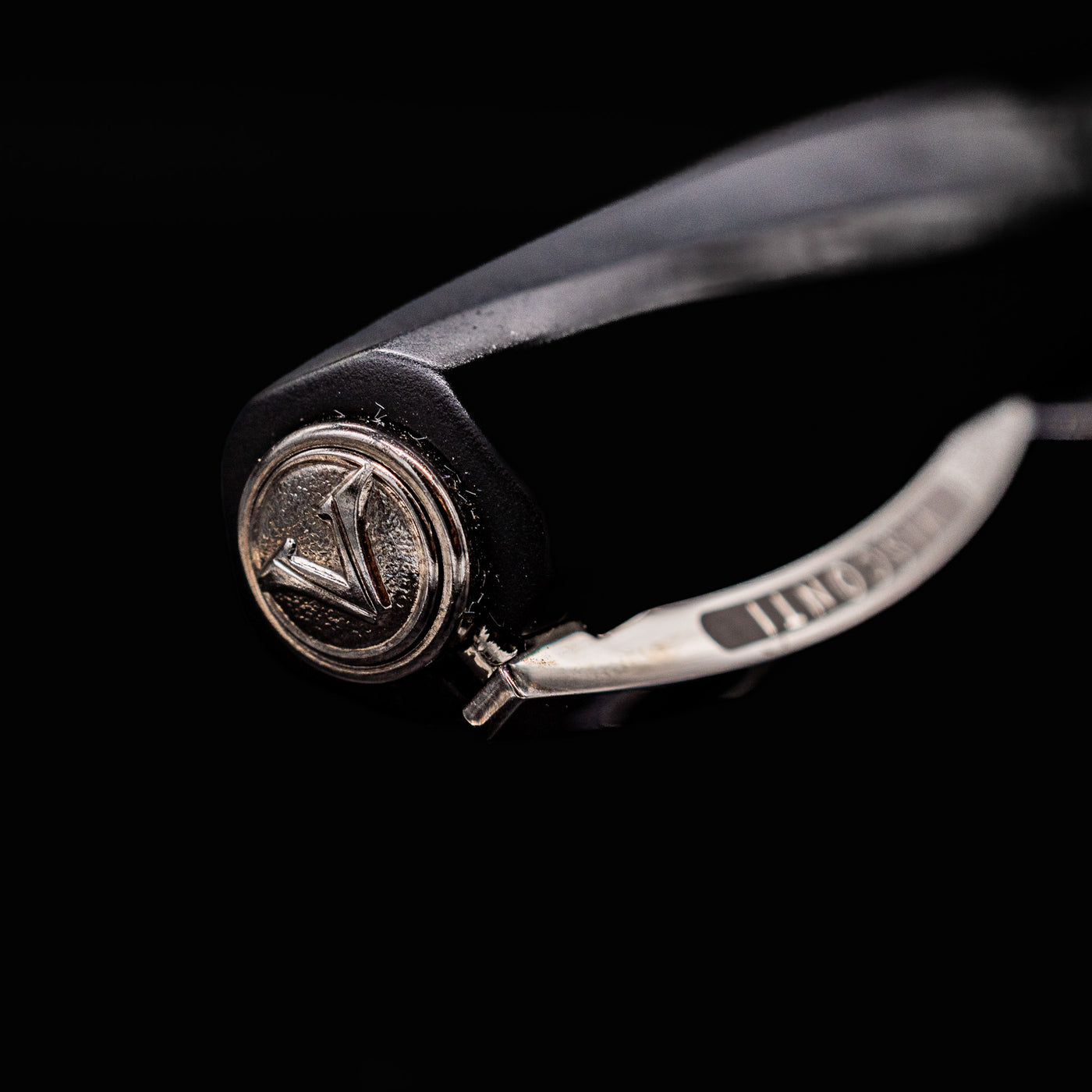 Close-up of Visconti Divina Matte Black Fountain Pen cap finial featuring raised V logo