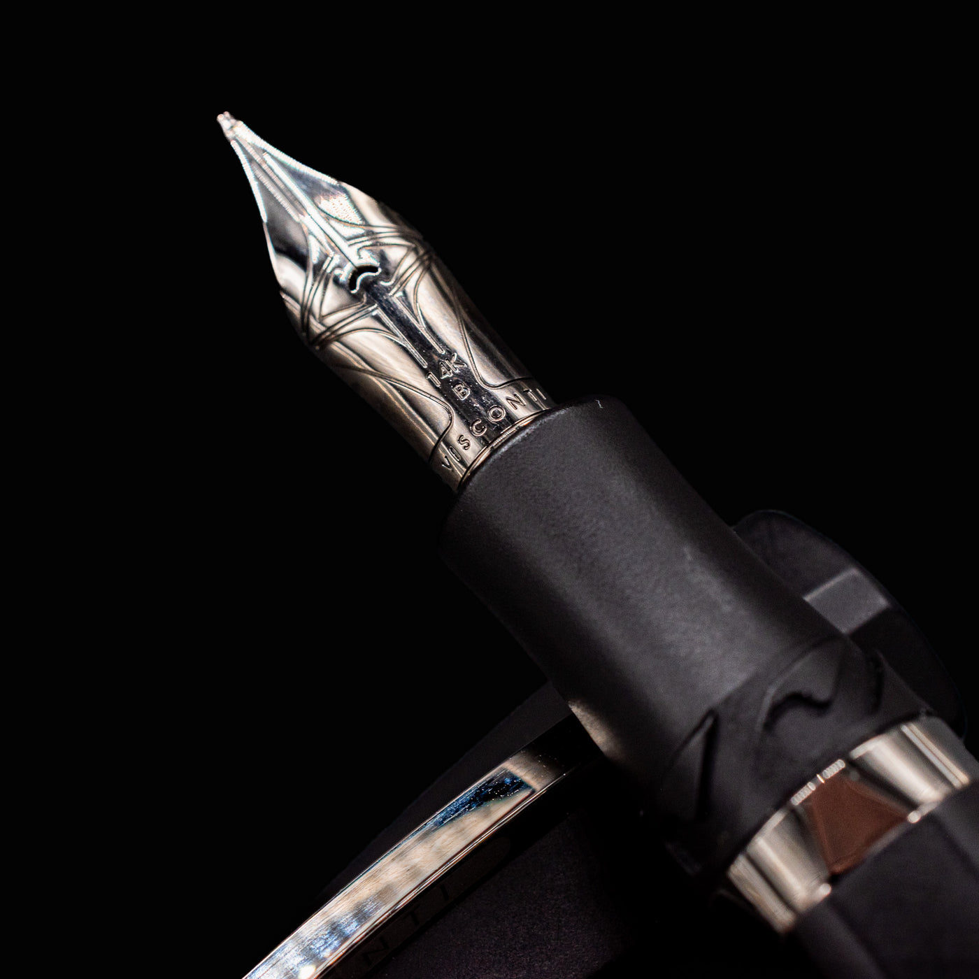 Macro detail of Visconti Divina Matte Black Fountain Pen silver nib with engraved Visconti logo