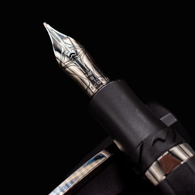 Macro detail of Visconti Divina Matte Black Fountain Pen silver nib with engraved Visconti logo