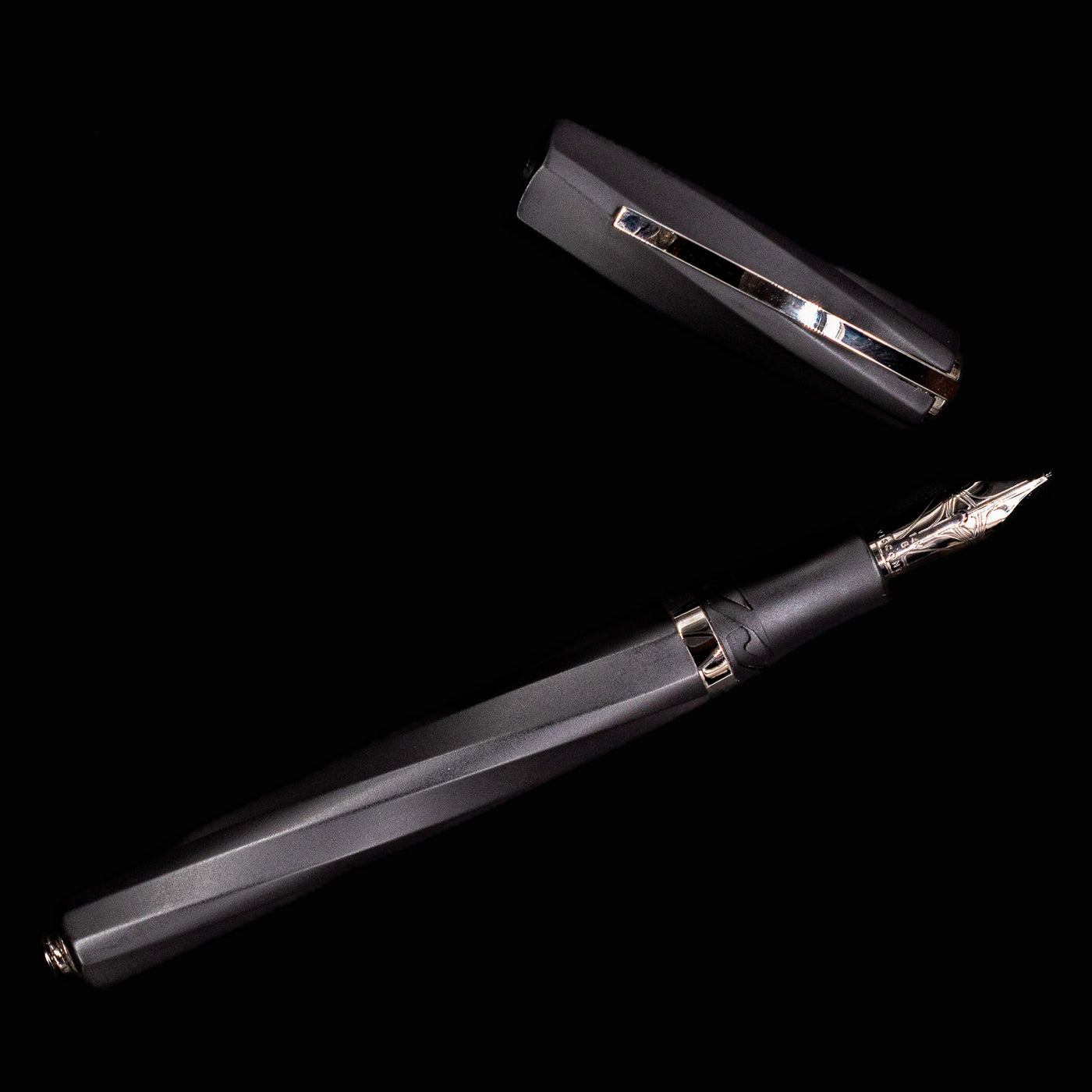 Uncapped Visconti Divina Matte Black Fountain Pen displayed full length on solid black background