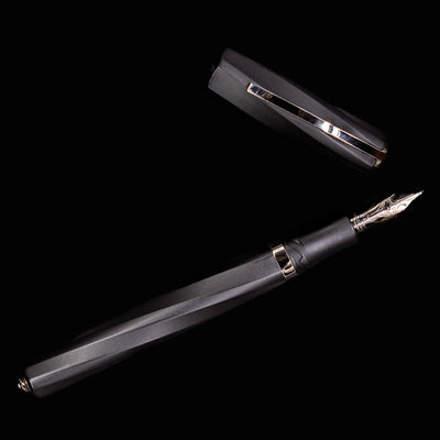 Uncapped Visconti Divina Matte Black Fountain Pen displayed full length on solid black background