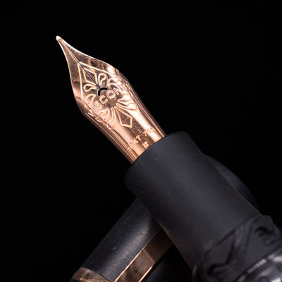Visconti Homo Sapiens Close-up of a decorative fountain pen 18k gold nib on a black background