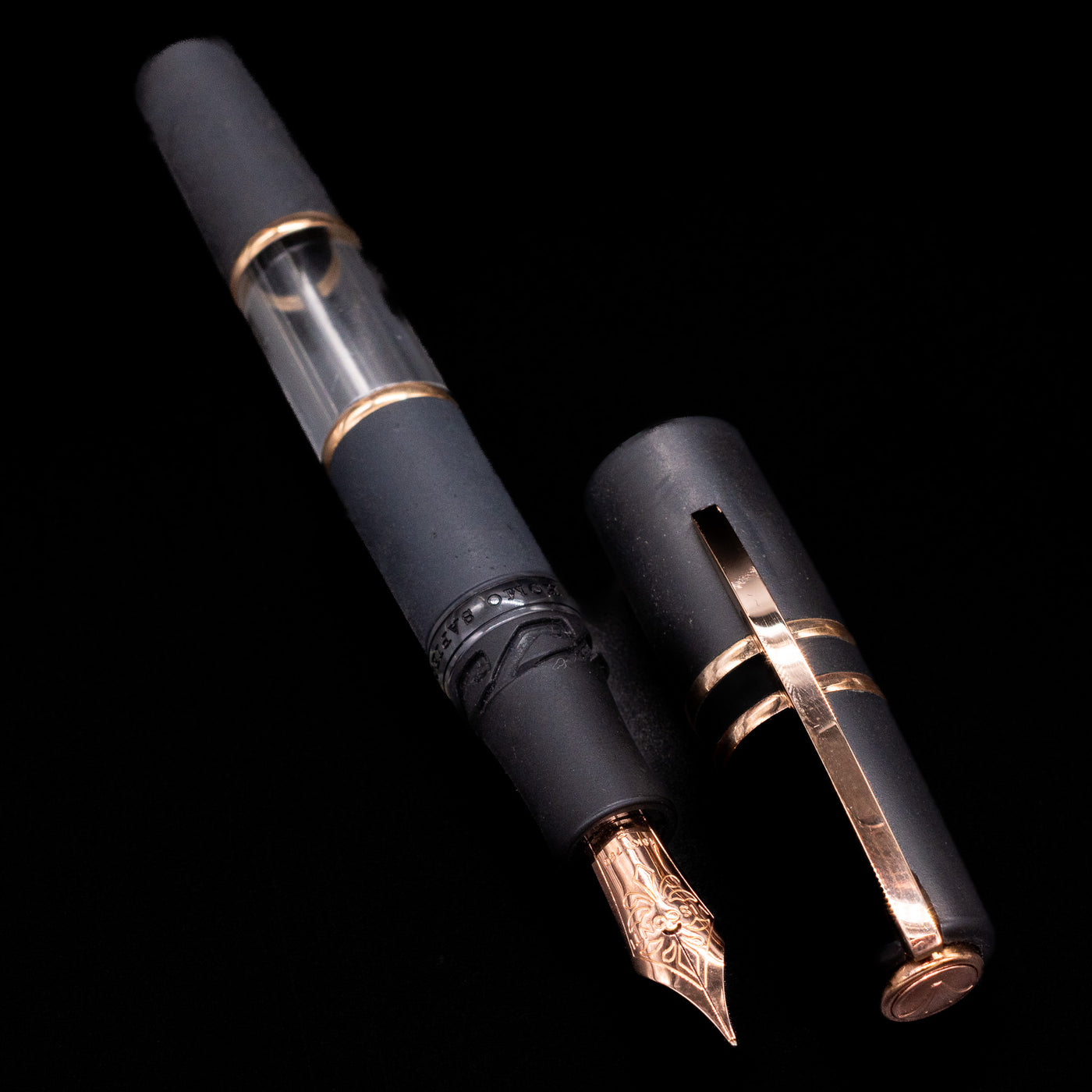 Visconti fountain pen with black and rose gold accents on a black background