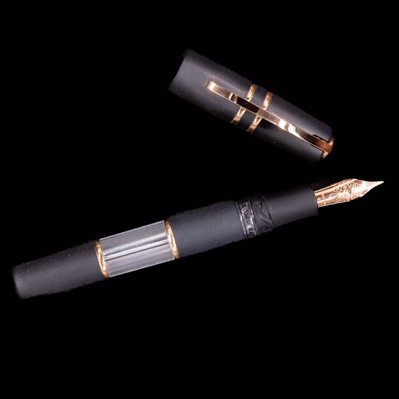 Fountain pen with black and rose gold trim on a black background