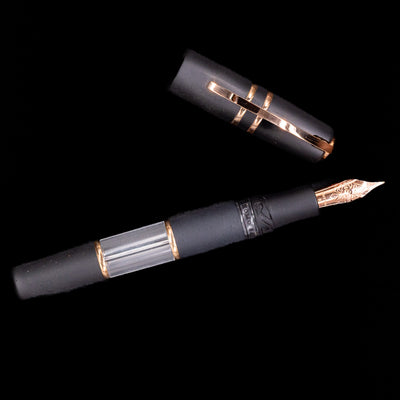Fountain pen with black and rose gold trim on a black background