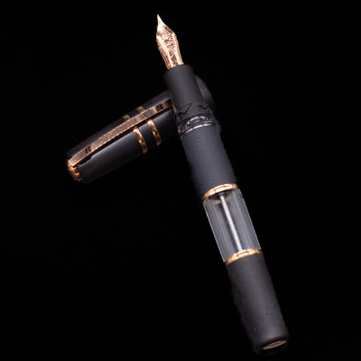 Visconti Lava Fountain pen with black and gold accents on a black background