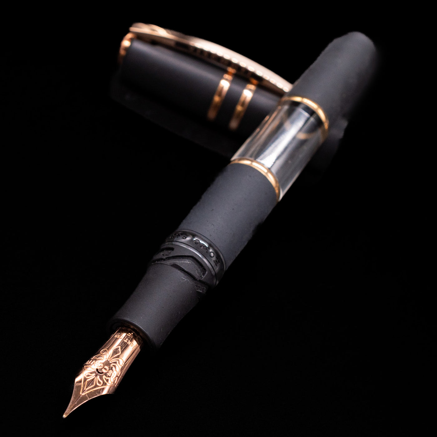 Visconti Homo Sapiens lava fountain pen with black and gold accents on a black background