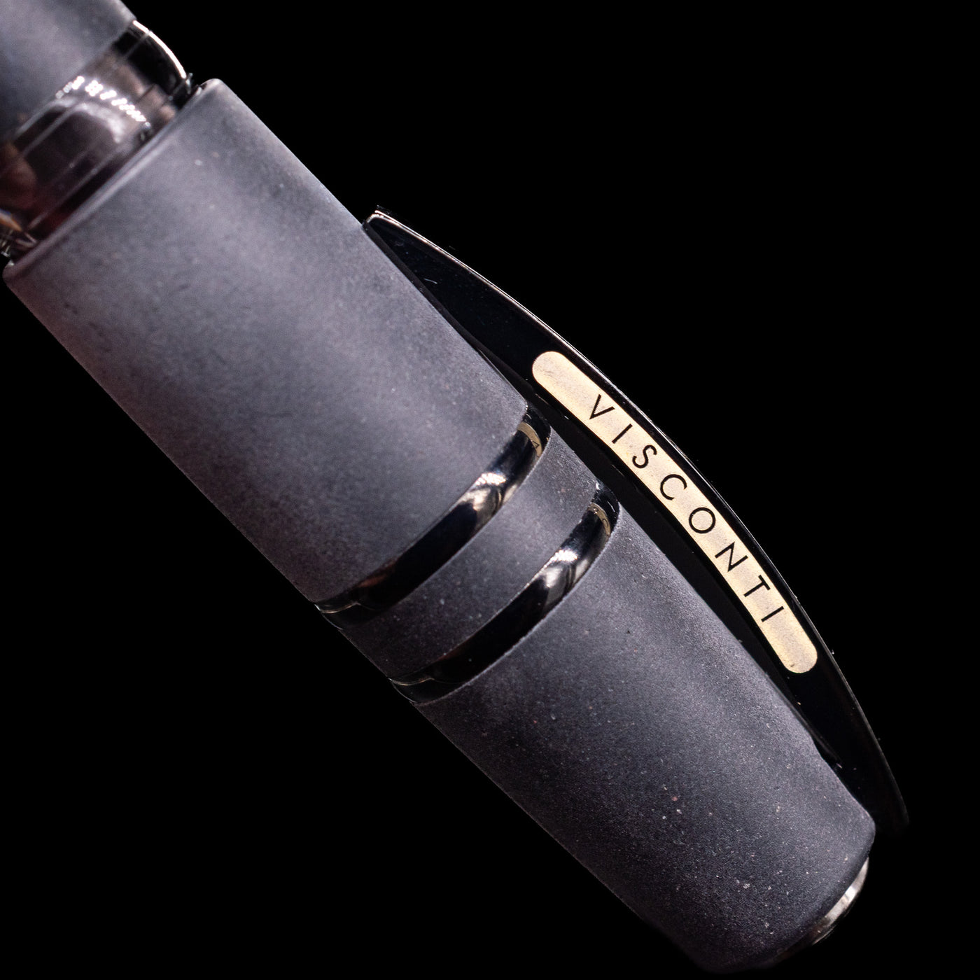 Black pen with 'Visconti' branding on the clip, on a black background