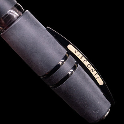 Black pen with 'Visconti' branding on the clip, on a black background