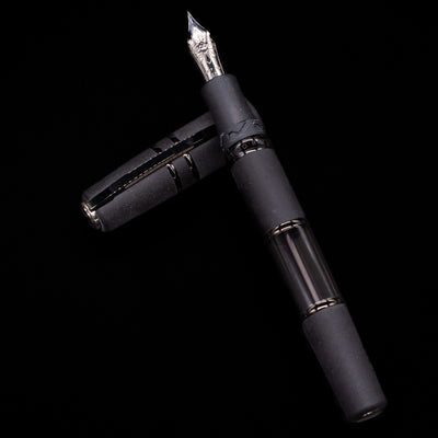 Visconti Homo Sapiens fountain pen with a black body and black PVD accents on a black background