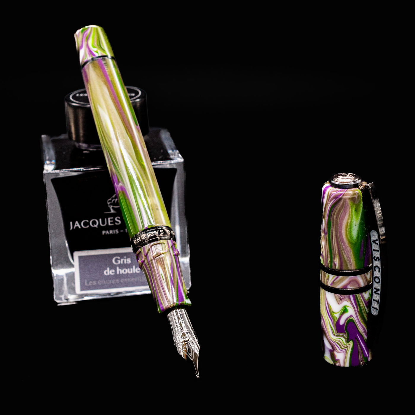Open Visconti Homo Sapiens Lotus Garden Fountain Pen with detached cap beside ink bottle