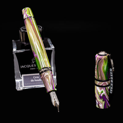 Open Visconti Homo Sapiens Lotus Garden Fountain Pen with detached cap beside ink bottle