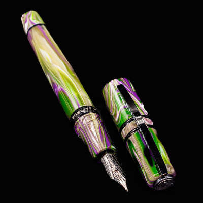 Visconti Homo Sapiens Lotus Garden Fountain Pen and cap displayed separately with vivid acrylic swirls