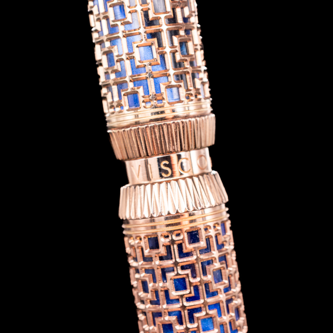 Detailed closeup of Visconti Looking East Fountain Pen’s deep blue pearlescent resin under rose gold filigree