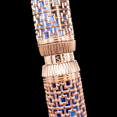 Detailed closeup of Visconti Looking East Fountain Pen’s deep blue pearlescent resin under rose gold filigree