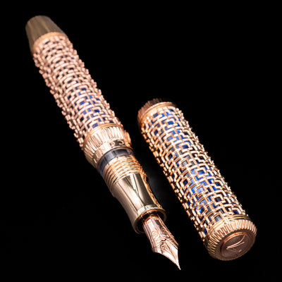 Side profile of Visconti Looking East Fountain Pen showing blue resin beneath rose gold architectural filigree design