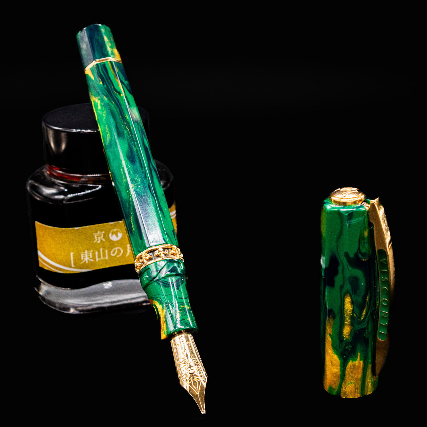 Visconti Medici Palazzo Riccardi fountain pen open with nib facing down, displayed next to an ink bottle