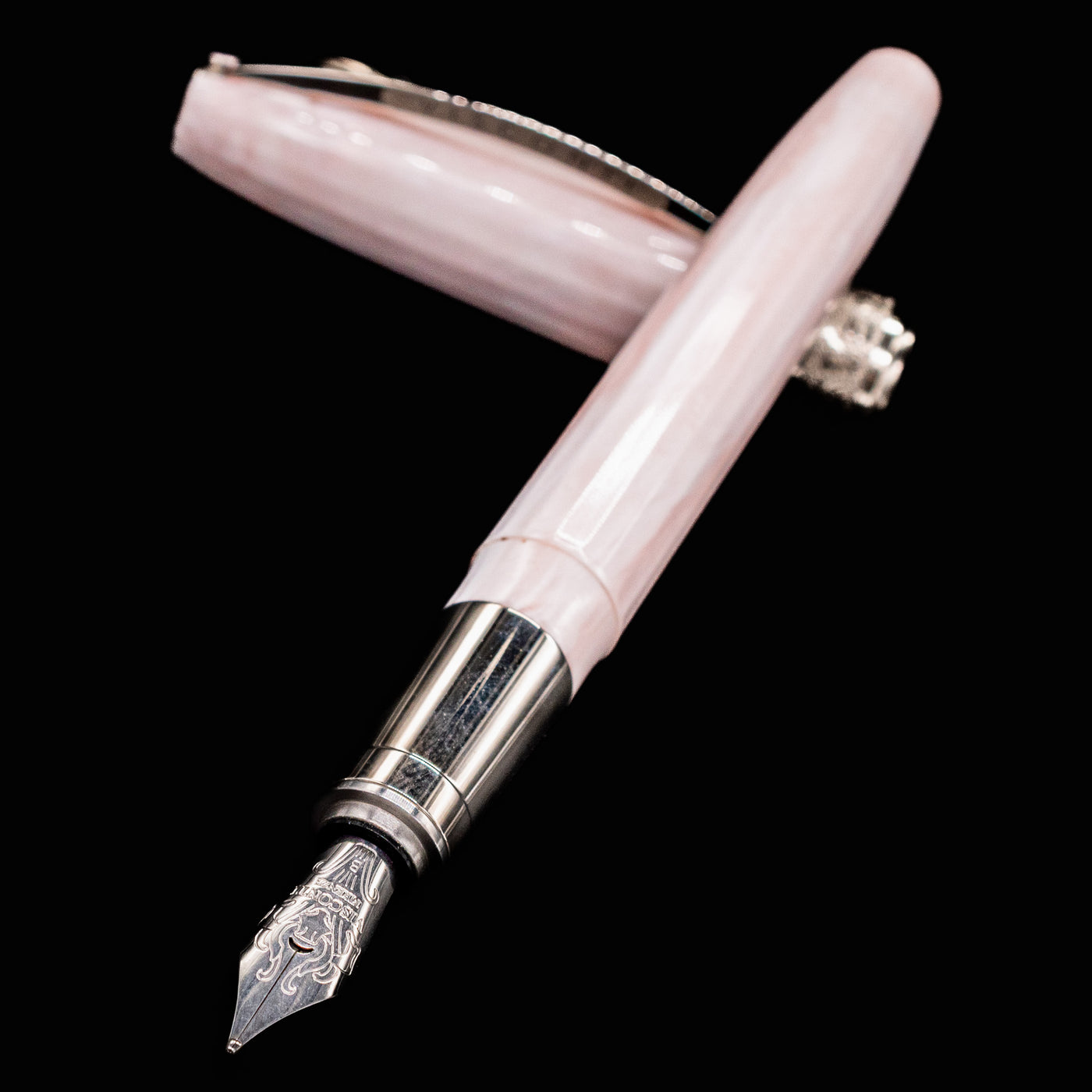 Close-up of Visconti Michelangelo Venus Rose Fountain Pen nib and faceted pink cap