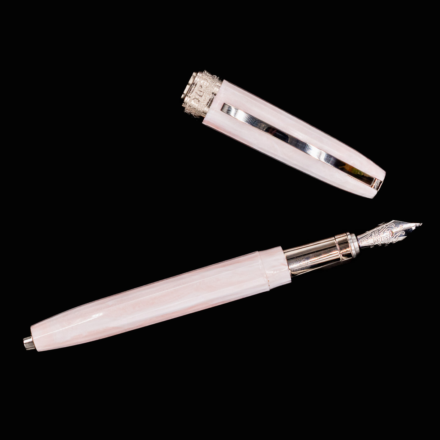 Flatlay of the Visconti Michelangelo Venus Rose Fountain Pen with cap and pen body side by side