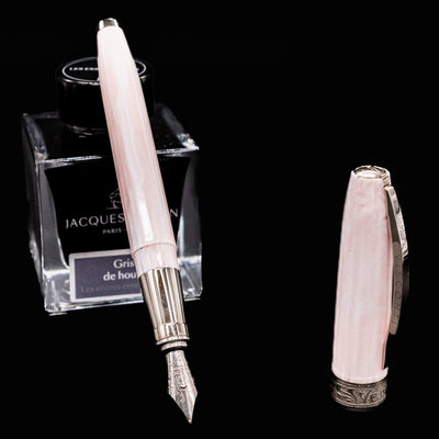 Visconti Michelangelo Venus Rose Fountain Pen uncapped with nib exposed beside Jacques Herbin ink