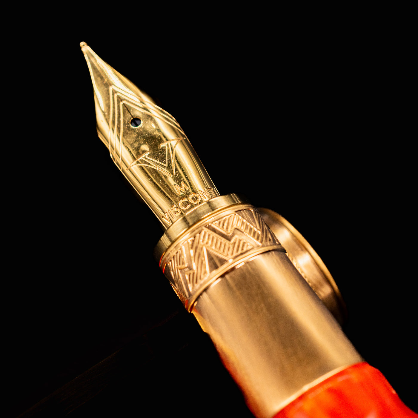 Close-up of Visconti Mirage Mythos Demeter fountain pen nib showing intricate bronze engravings and medium nib marking