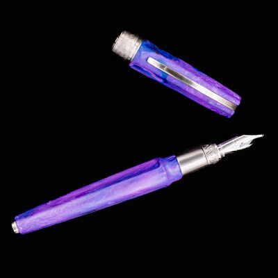 Flat lay of Visconti Mirage Mythos Persephone Fountain Pen with nib and cap placed above