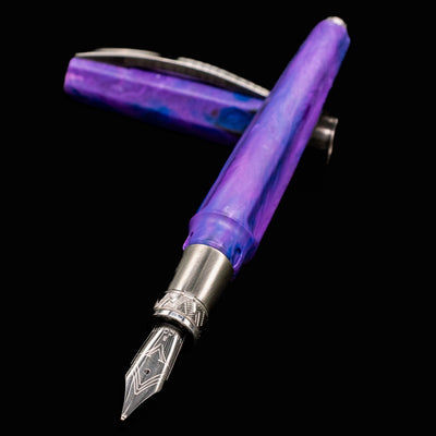 Close-up angled view of Visconti Mirage Mythos Persephone Fountain Pen with stainless steel nib exposed and cap in background