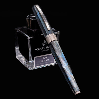 Visconti Mirage Mythos Poseidon Fountain Pen displayed with Jacques Herbin Gris de Houle ink bottle