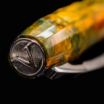 Close-up of Visconti Van Gogh Café Terrace fountain pen cap showing silver V emblem on finial