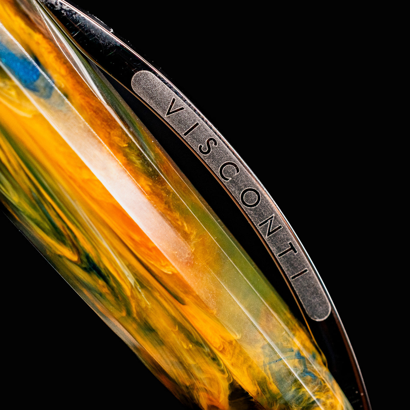 Macro detail of Visconti Van Gogh Café Terrace at Night pen clip with engraved branding