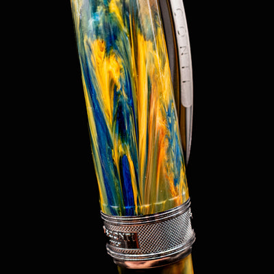 Close-up of swirled yellow, blue, and orange resin on Visconti Van Gogh Café Terrace fountain pen barrel