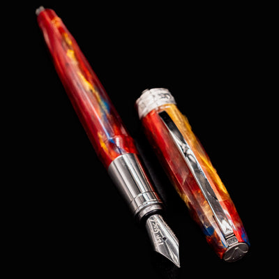 Flat lay of open Visconti Van Gogh Red Vineyard Fountain Pen with marbled resin barrel and separate cap on black background
