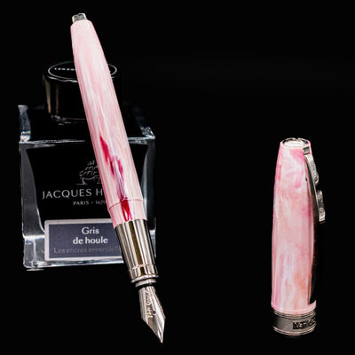 Uncapped Visconti Van Gogh Souvenir de Mauve Fountain Pen next to ink bottle showing nib and barrel