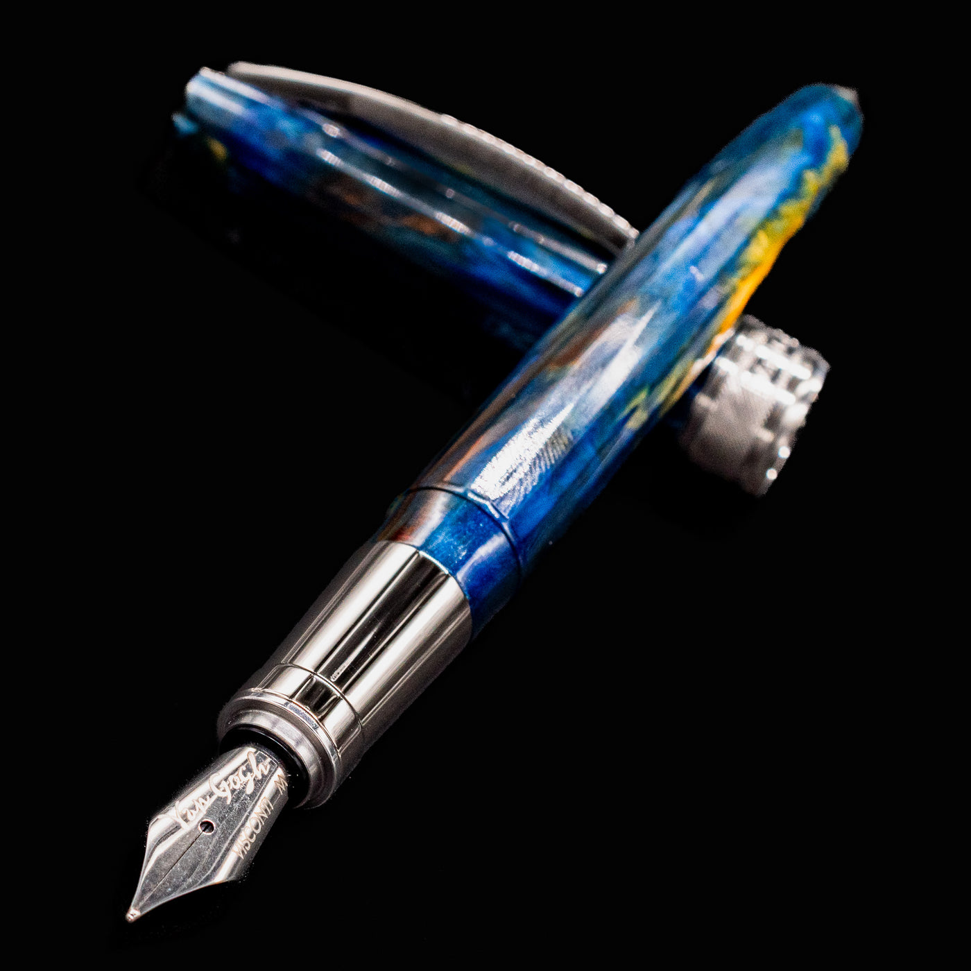 Close-up of Visconti Van Gogh Starry Night Fountain Pen nib and vibrant acrylic body with silver trim.