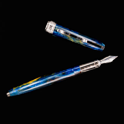 Top-down view of Visconti Van Gogh Starry Night Fountain Pen and cap against a black background.