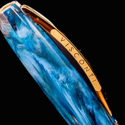 Macro of Visconti Van Gogh Wheatfield with Crows fountain pen cap clip engraved with VISCONTI branding in gold.