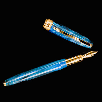 Flat lay of Visconti Van Gogh Wheatfield with Crows fountain pen and cap, displaying its painterly swirls and gold hardware.
