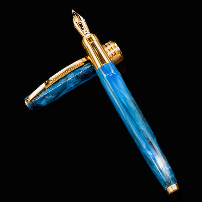 Visconti Van Gogh Wheatfield with Crows fountain pen with cap and nib arranged in display position on black background.