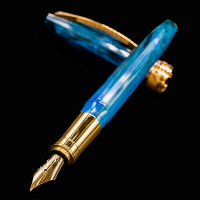 Close-up of Visconti Van Gogh Wheatfield with Crows fountain pen nib and section in blue resin with gold accents.
