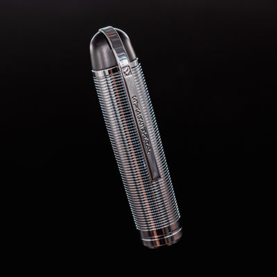 Close-up of the Wahl Eversharp Skyline Fountain Pen cap in black and chrome with vertical engraving and engraved clip.