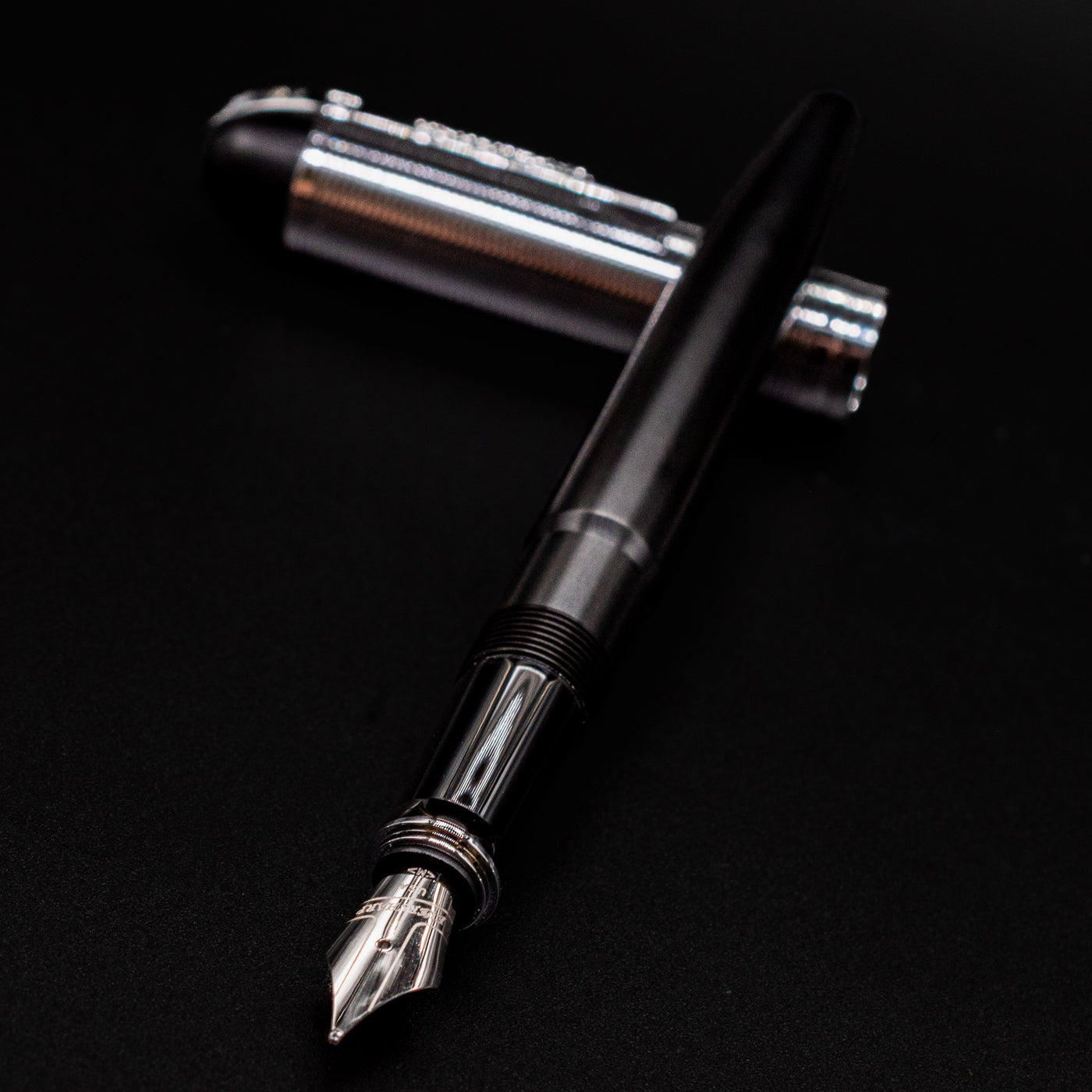 Diagonal angle of the uncapped Wahl Eversharp Skyline Fountain Pen - Black & Chrome with cap placed behind the pen.